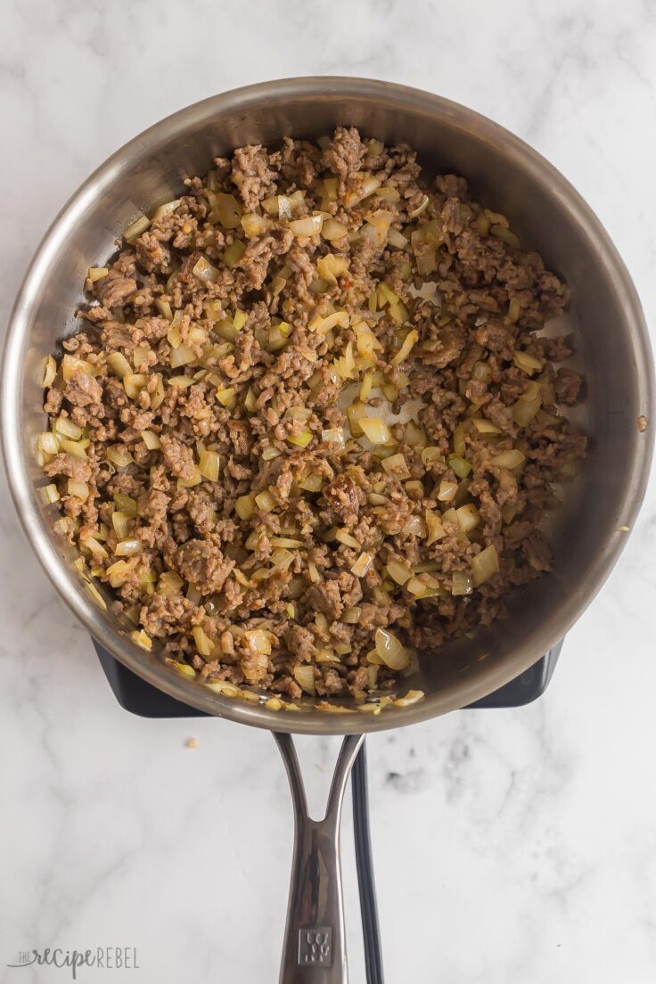 meat and onions cooking in skillet