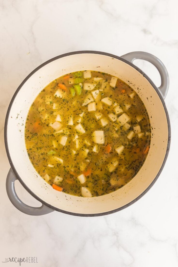 potatoes and broth added to vegetables in soup pot