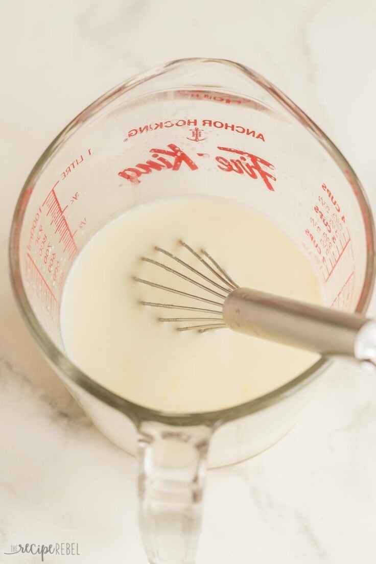 milk added to roux in glass measuring cup