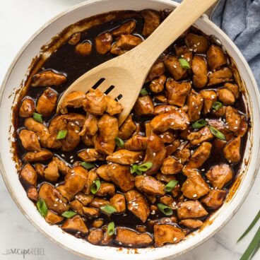 square image of teriyaki chicken in white pan.