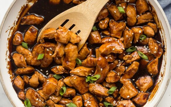 square image of teriyaki chicken in white pan.