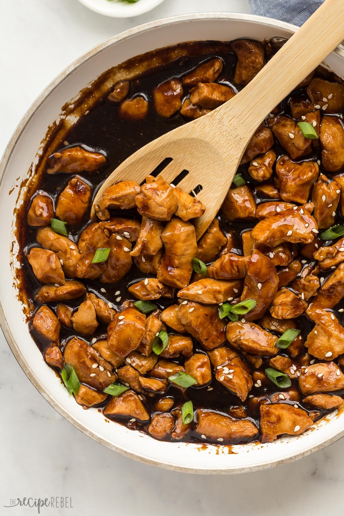 overhead image of teriyaki chicken in white skillet.