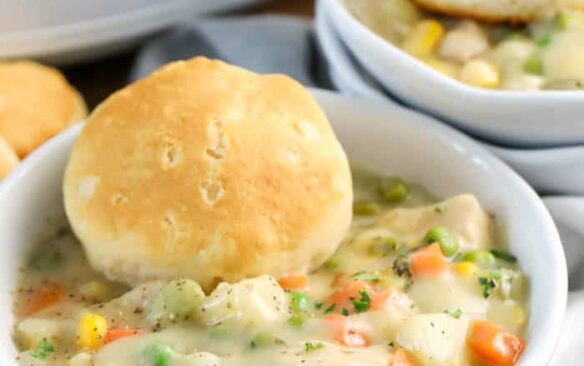 crockpot chicken pot pie in bowl with biscuit