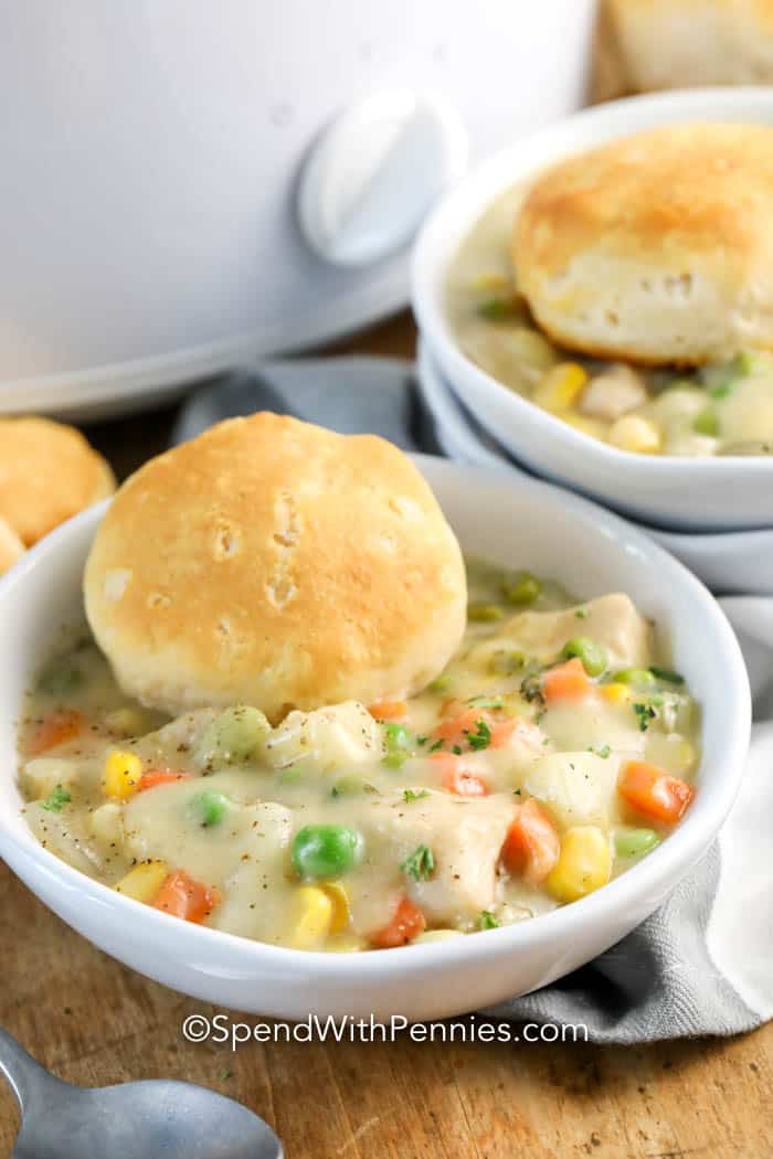 crockpot chicken pot pie in bowl with biscuit