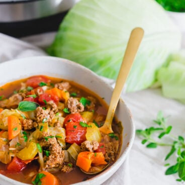 instant pot cabbage soup in bowl with spoon
