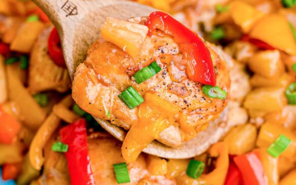 close up image of crockpot hawaiian chicken on blue plate