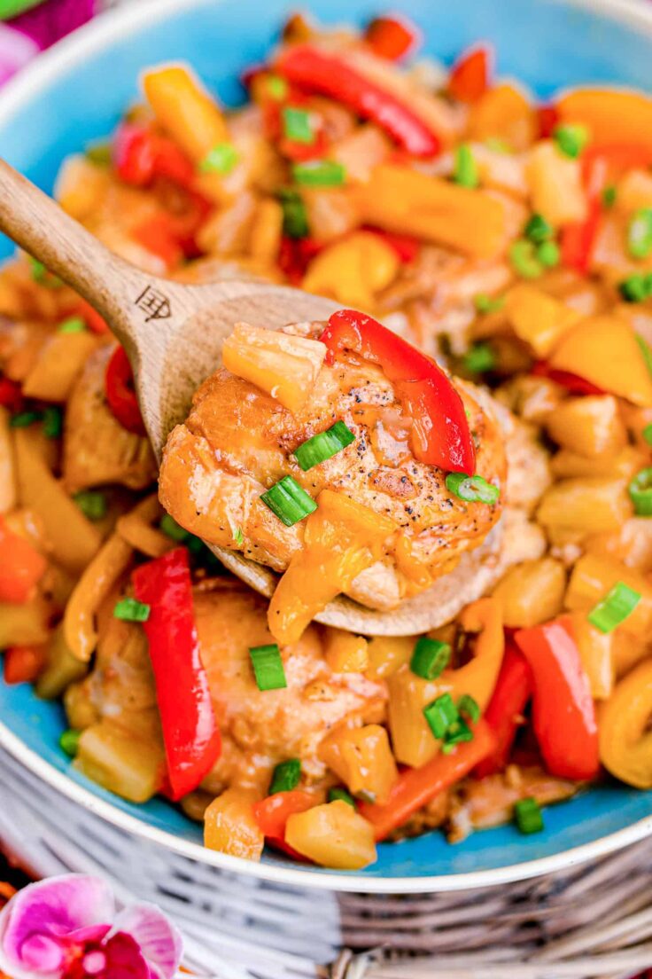 close up image of crockpot hawaiian chicken on blue plate