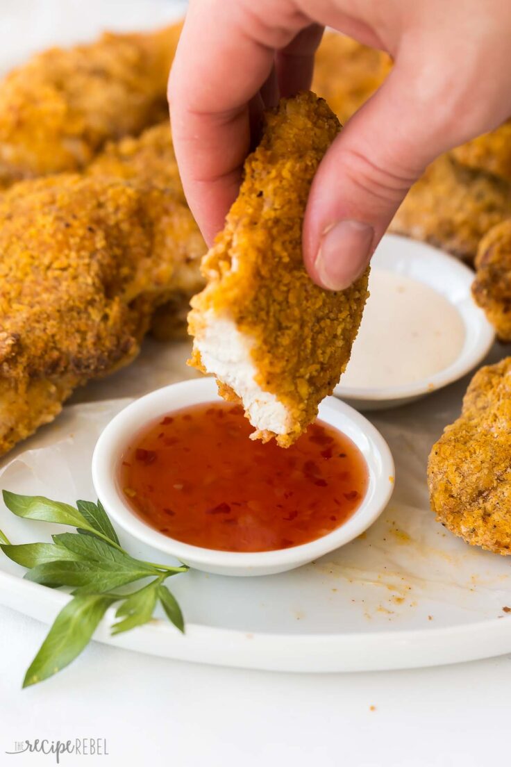 air fryer fried chicken piece being dipped in sauce