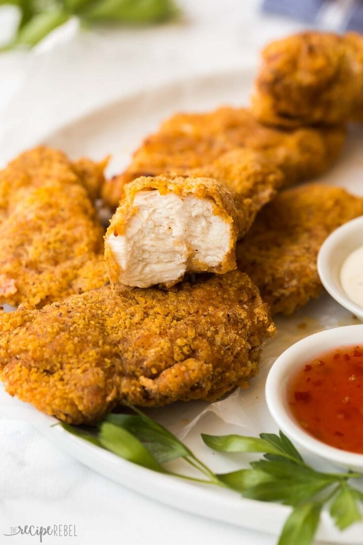 close up image of air fryer fried chicken breast with a bite taken