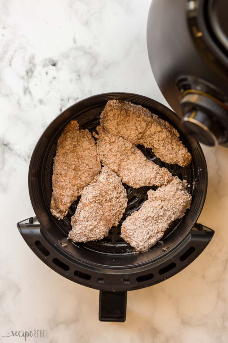 uncooked air fryer fried chicken in air fryer basket