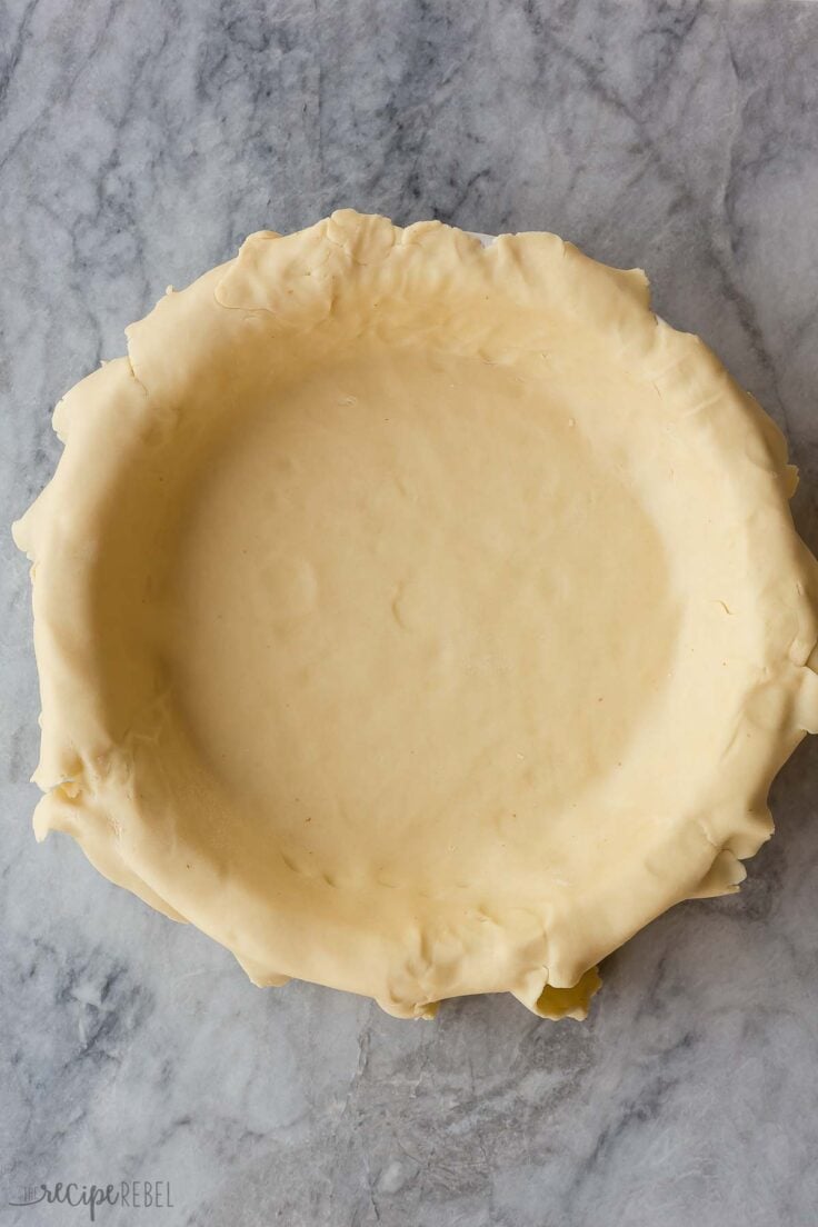bottom pie crust for apple pie rolled out in pie plate
