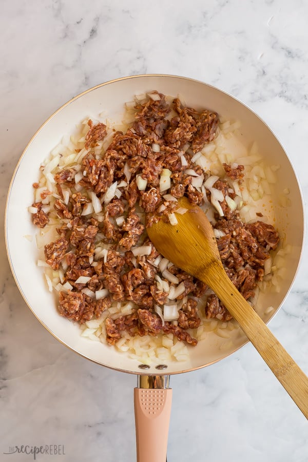 cooking italian sausage and onions in pan