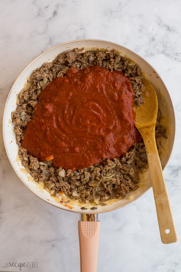 add tomato sauce to meat in skillet