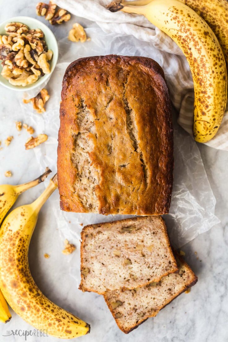 overhead image of banana nut bread with two slices cut