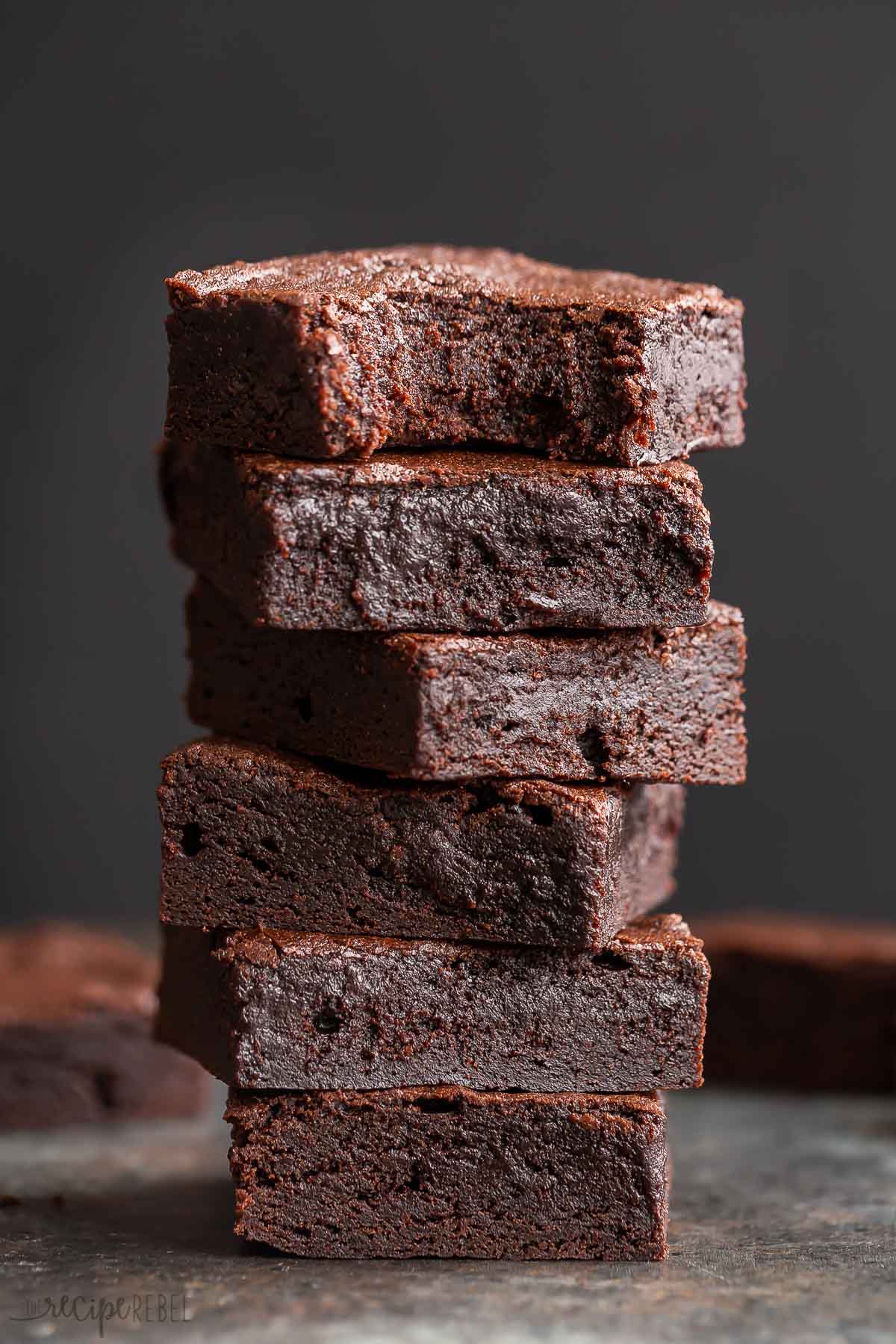 tall stack of brownies on black background.