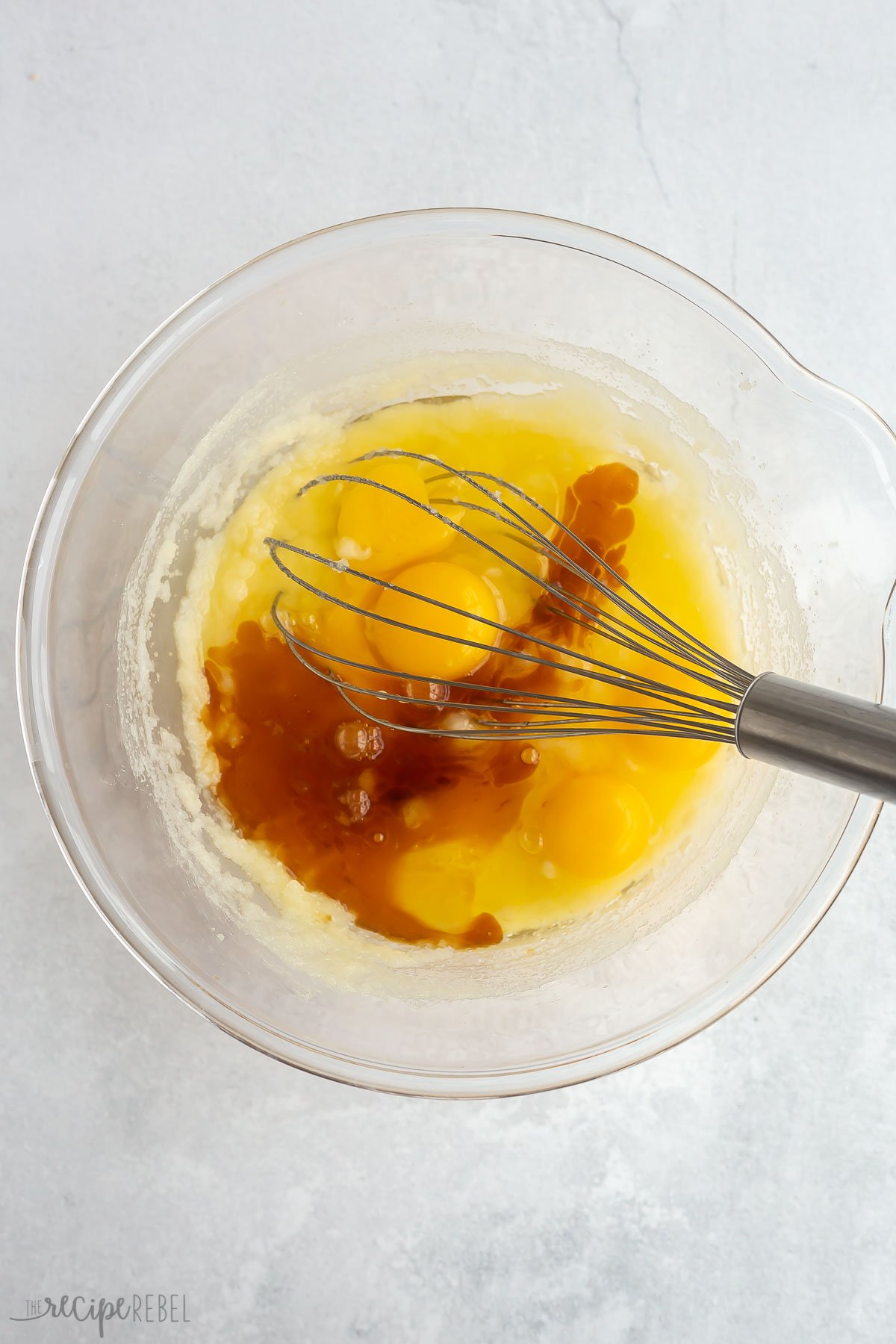 eggs and vanilla added to glass bowl.