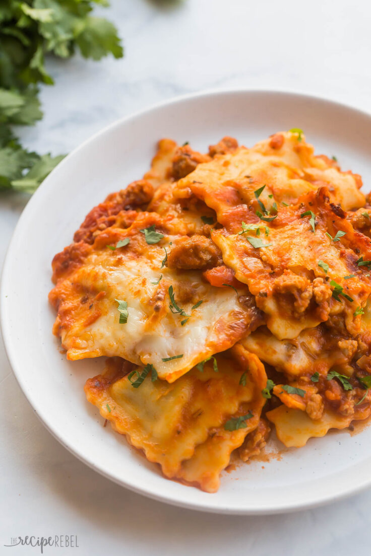 close up image of cheesy baked ravioli on plate
