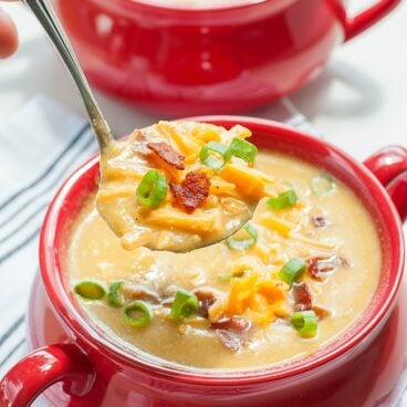 slow cooker cauliflower and sweet potato soup in red bowl
