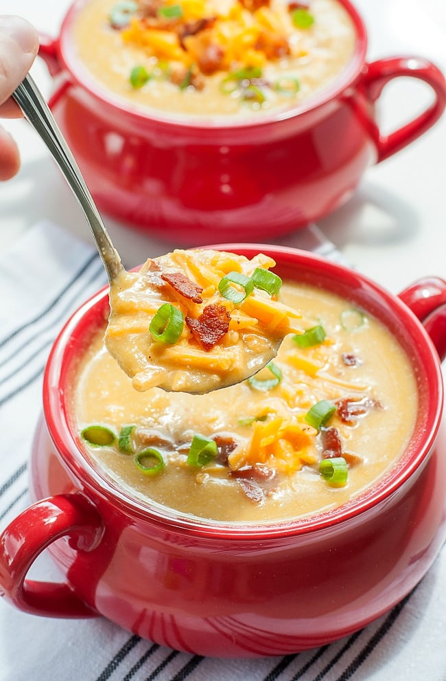 slow cooker cauliflower and sweet potato soup in red bowl