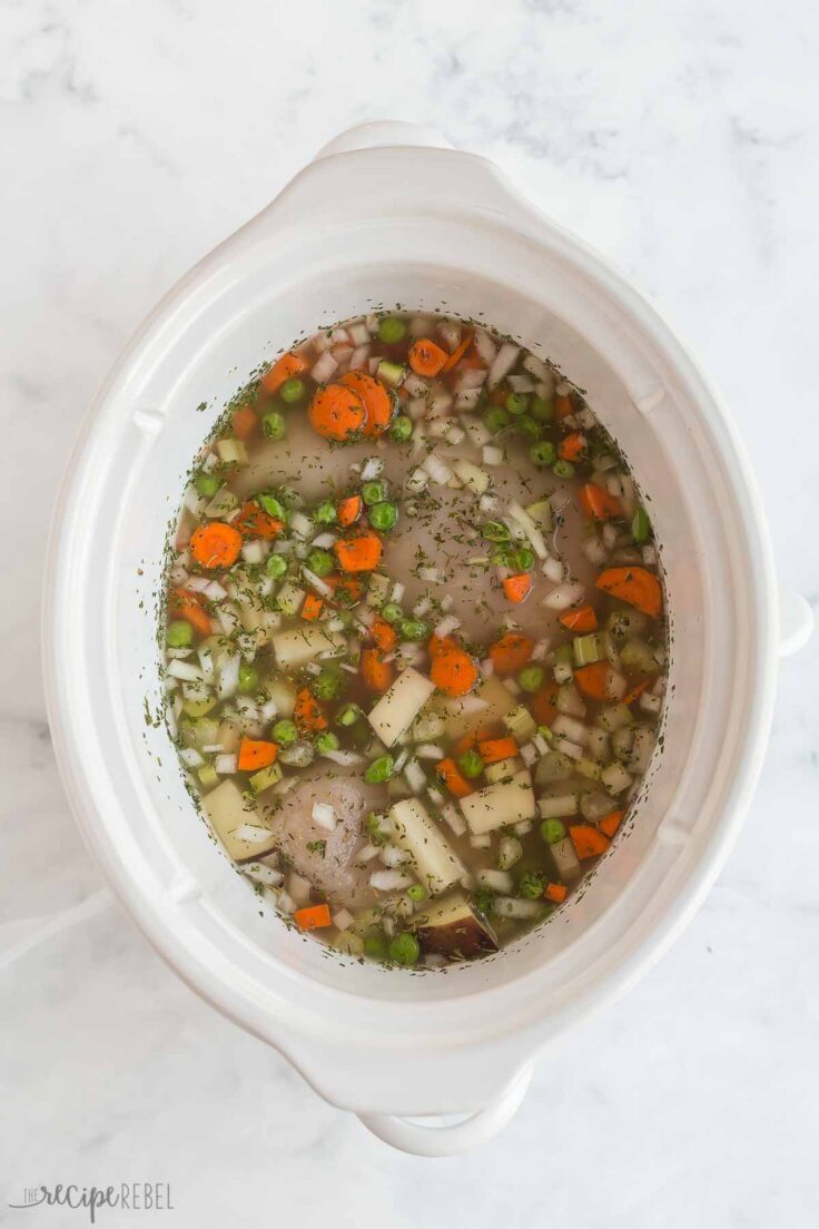 uncooked vegetables and chicken in crockpot