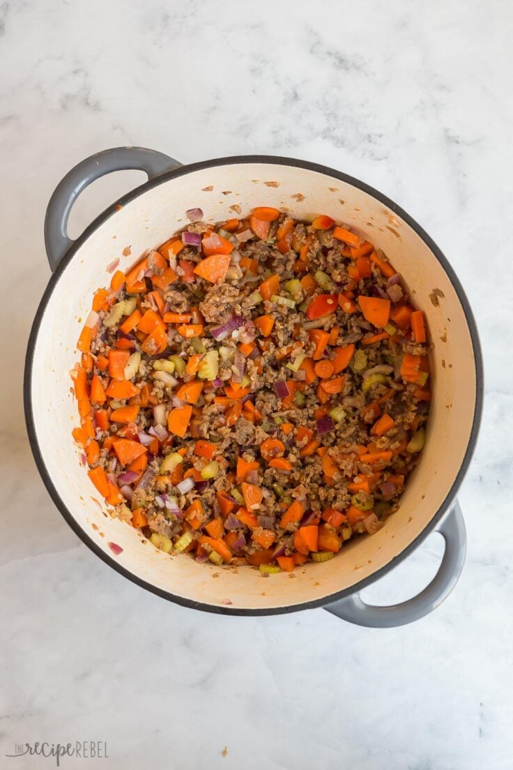 vegetables and italian sausage cooked in large soup pot