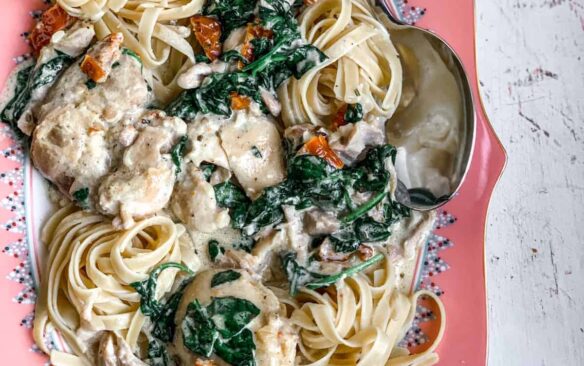 overhead image of slow cooker tuscan chicken thighs on plate