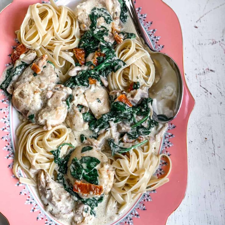 overhead image of slow cooker tuscan chicken thighs on plate