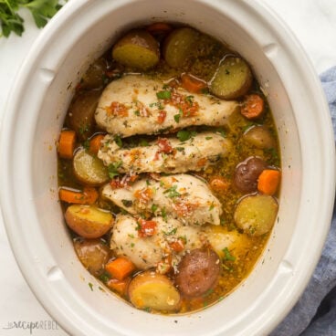 square image of crockpot chicken and potatoes with sun dried tomato sauce