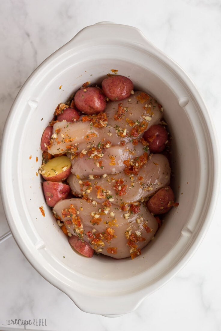 sun dried tomato sauce poured on top of chicken breasts in slow cooker