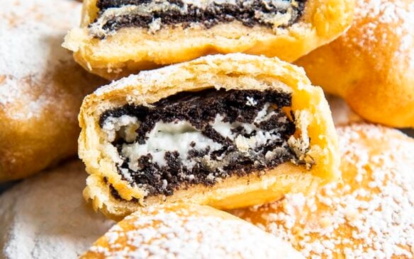 close up image of air fried oreos dusted with powdered sugar