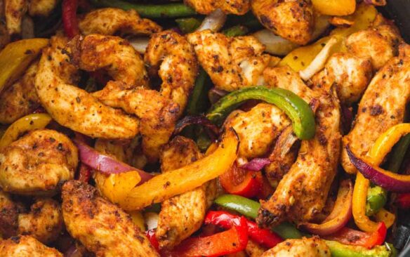 chicken fajitas in air fryer basket close up