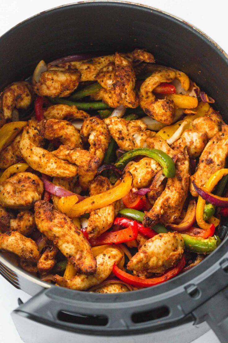 chicken fajitas in air fryer basket close up