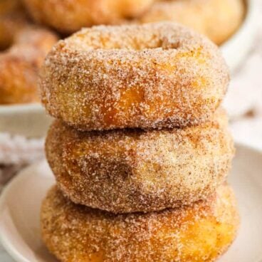 stack of three air fryer donuts coated in cinnamon sugar