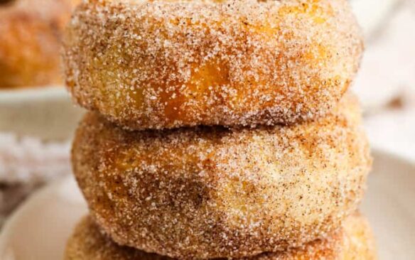 stack of three air fryer donuts coated in cinnamon sugar