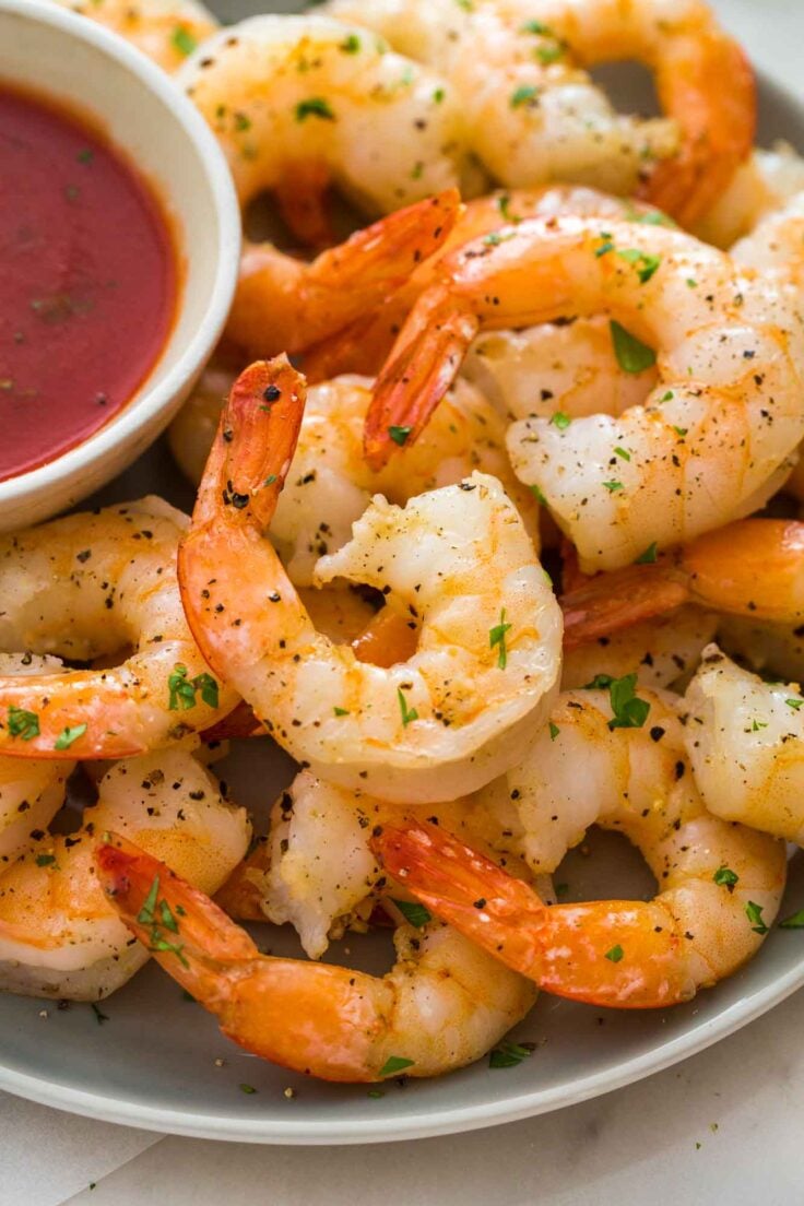 close up image of air fryer shrimp with cocktail sauce