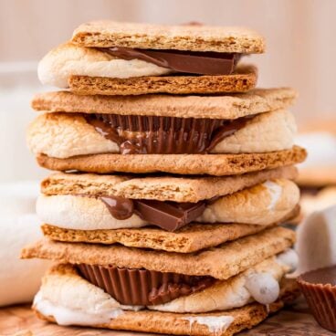 stack of four air fryer smores with chocolate and peanut butter cups