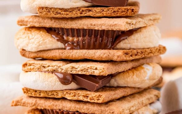 stack of four air fryer smores with chocolate and peanut butter cups