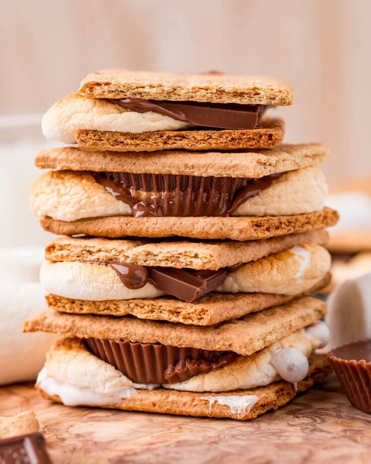 stack of four air fryer smores with chocolate and peanut butter cups