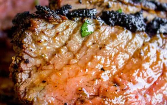 close up tri tip image with red juicy interior and black crust
