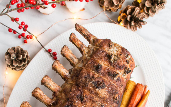 christmas roast rack of pork on a white platter