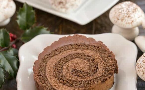 one piece of buche de noel on a white plate