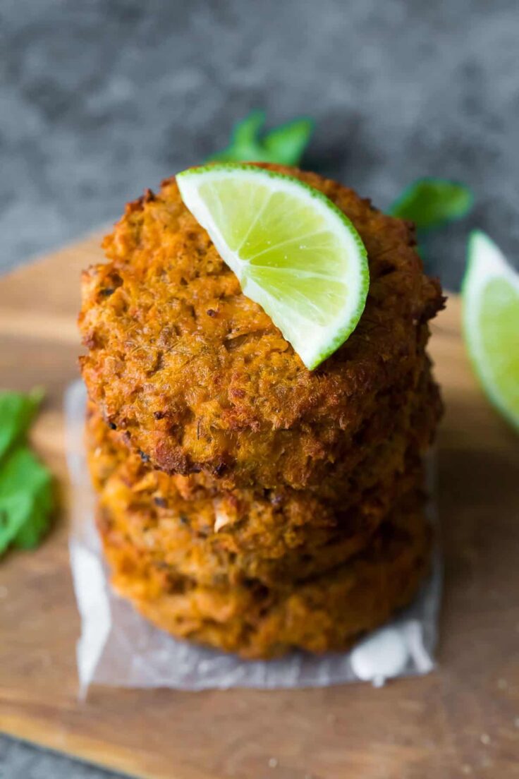 make ahead thai salmon patties stacked with lime slice on top