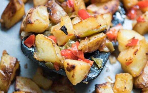 oven roasted breakfast potatoes on a sheet pan with a spatula