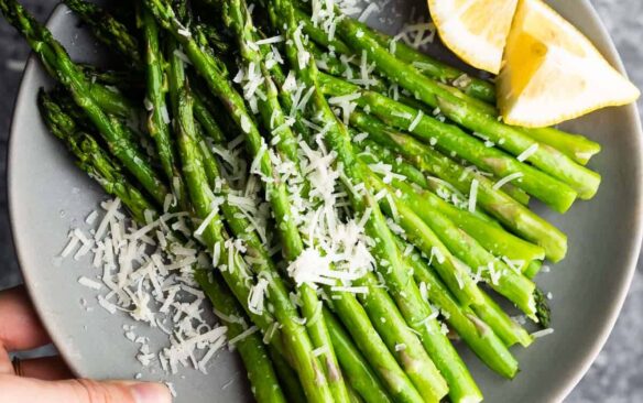 overhead image of air fryer asparagus on plate with parmesan and lemon