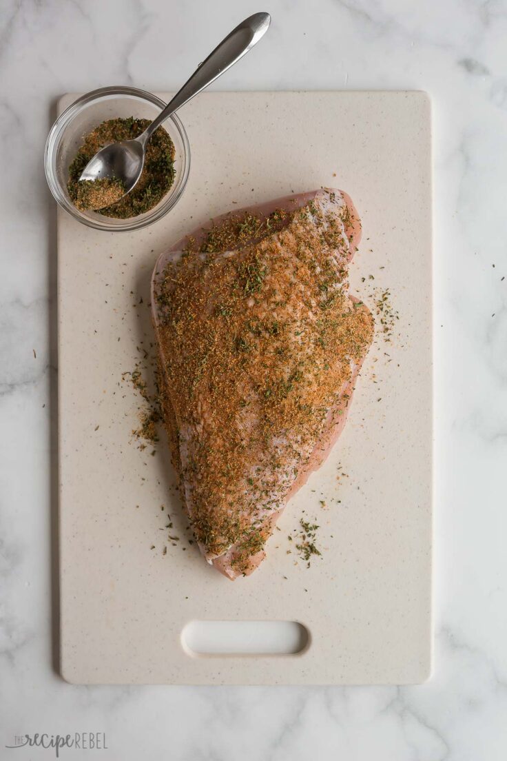 seasoned turkey breast on cutting board ready for the air fryer