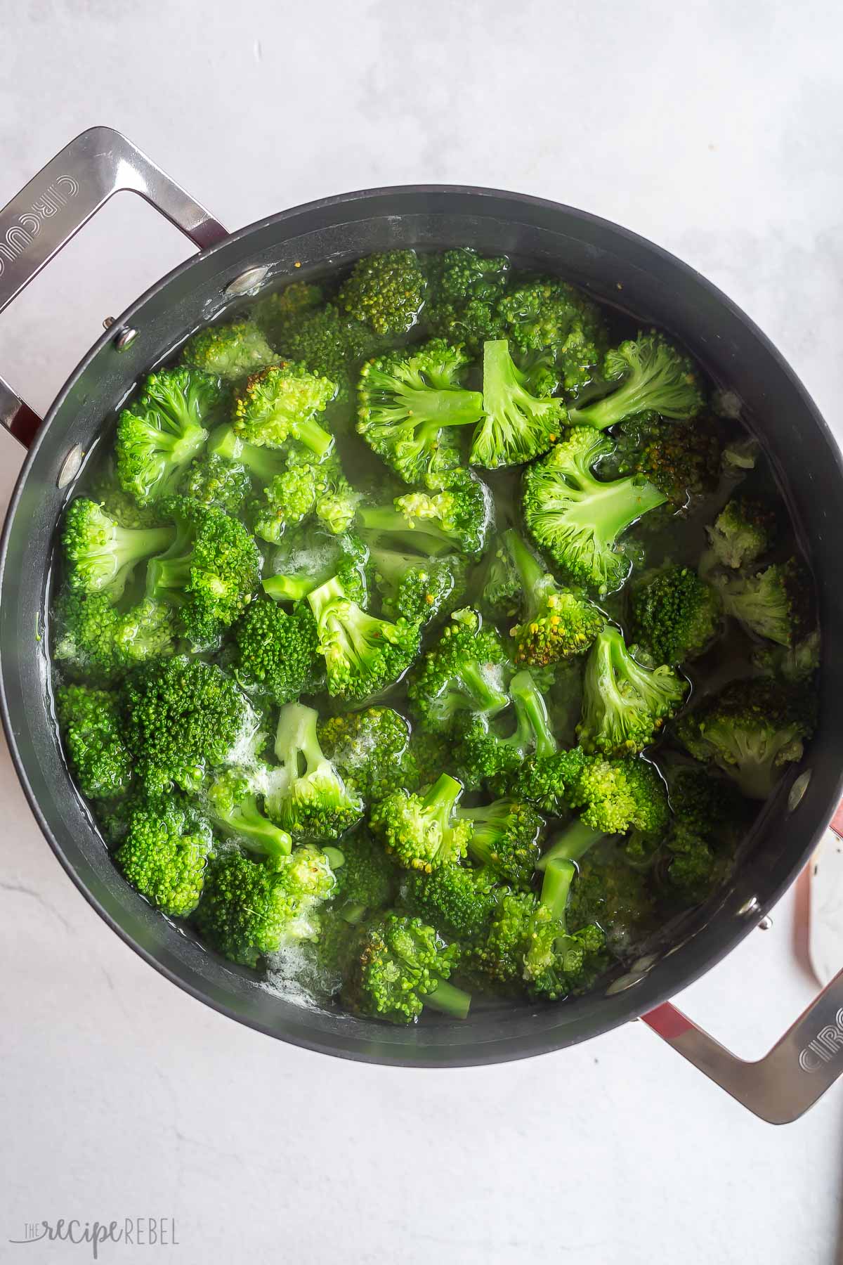 broccoli boiling in a black pot.