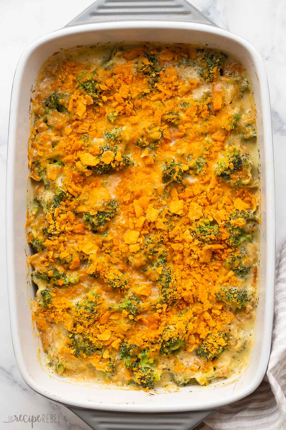 overhead image of baked broccoli casserole in grey dish.