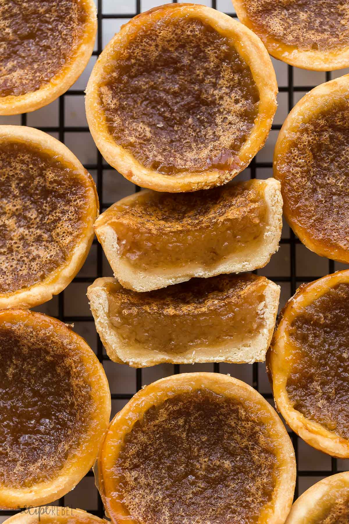 close up image of butter tart cut in half on cooling rack