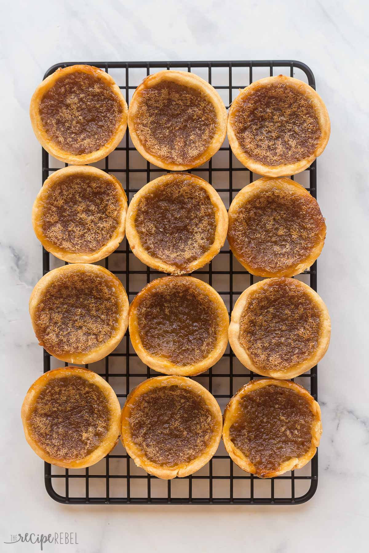 finished butter tarts on black cooling rack