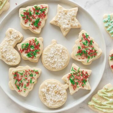 overhead image of christmas sugar cookies with white and red and green sprinkles